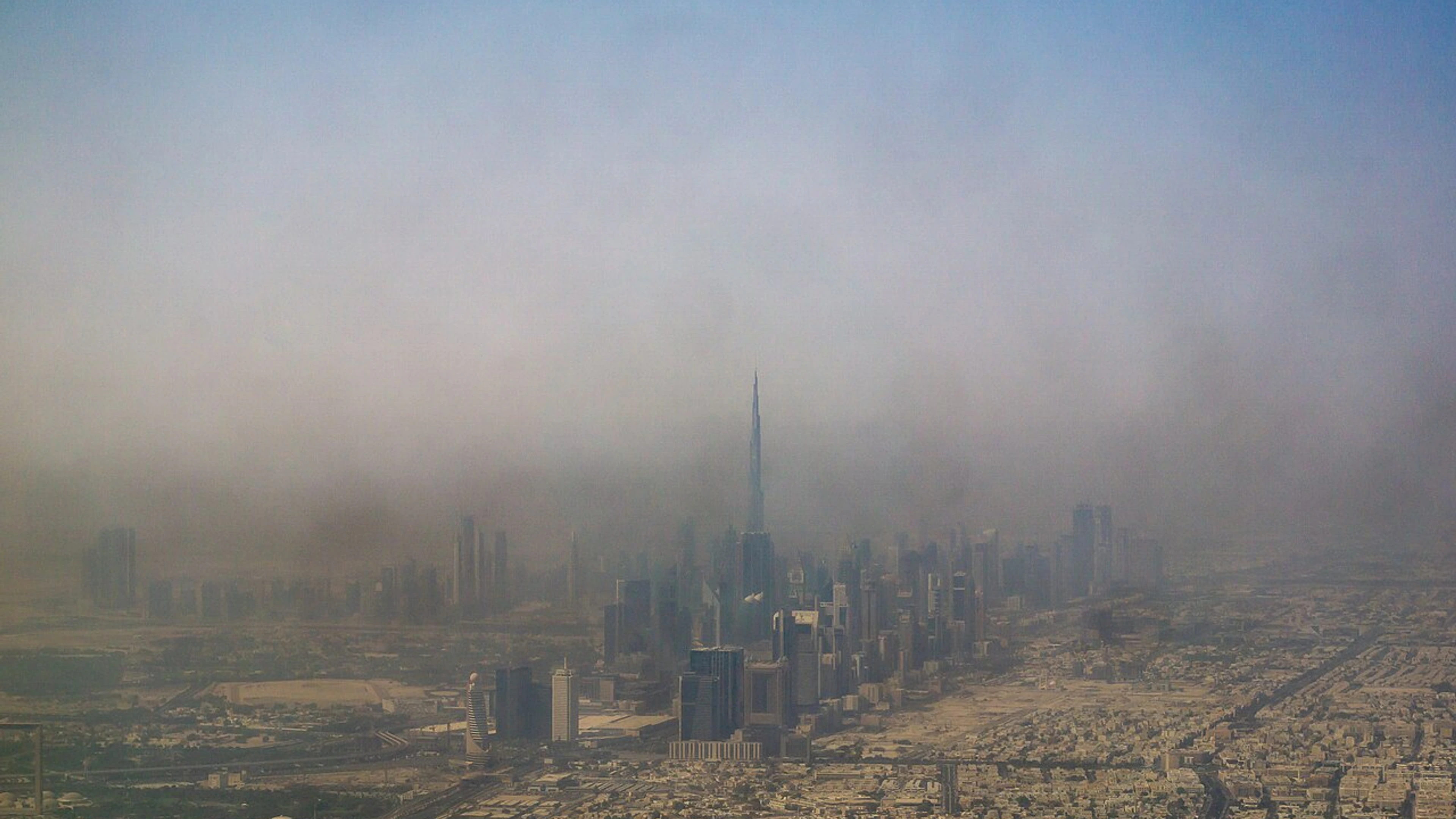 Dubai skyline with Burj Khalifa visible through haze