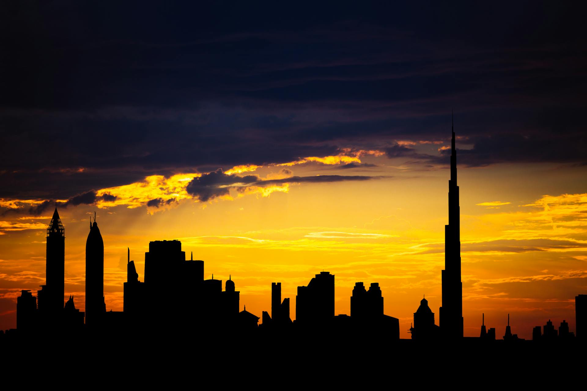 Dubai skyline silhouette at sunset with Burj Khalifa
